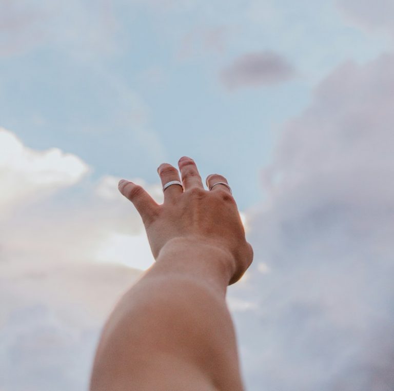 persons left hand raising up
